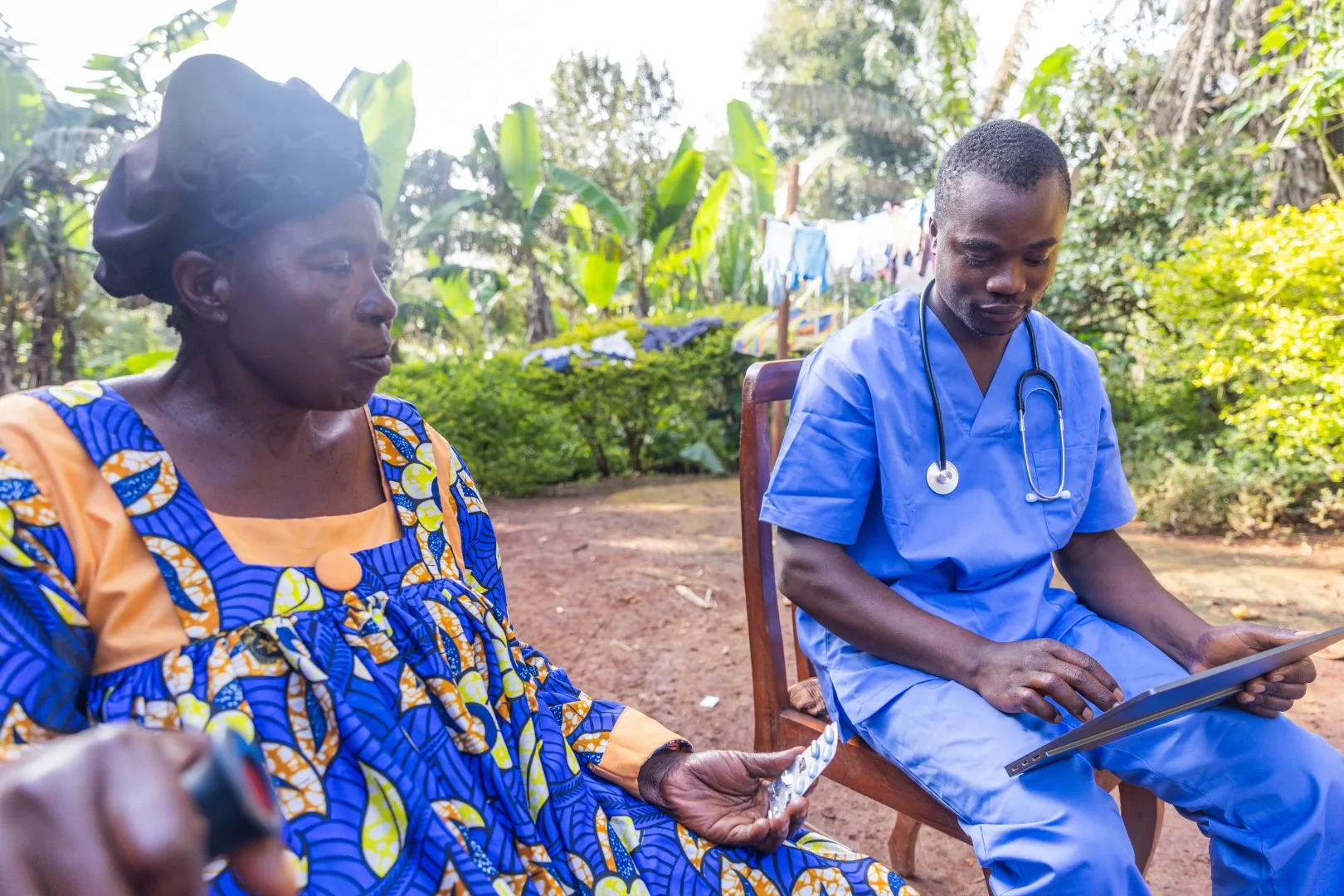A healthcare provider attending to a woman outdoors