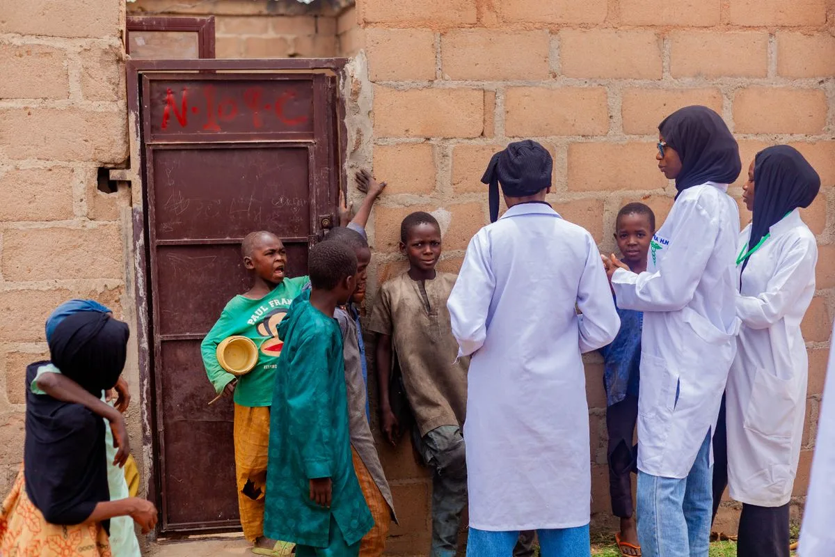 Community health workers speaking with children in Gombe, Nigeria